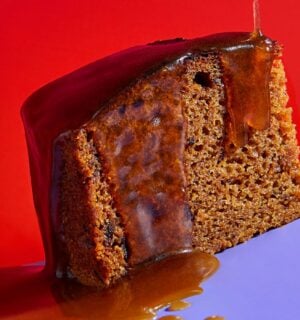 a slice of vegan sticky date pudding made with a plant-based butterscotch sauce