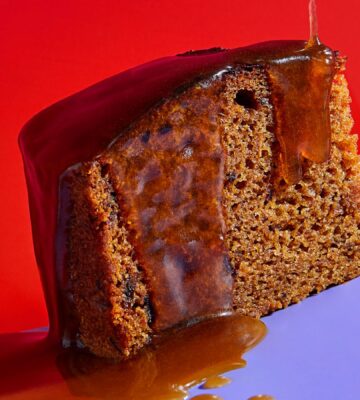 a slice of vegan sticky date pudding made with a plant-based butterscotch sauce