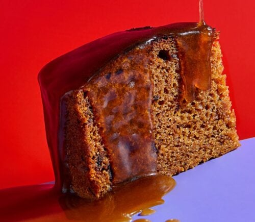 a slice of vegan sticky date pudding made with a plant-based butterscotch sauce