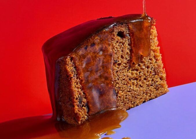 a slice of vegan sticky date pudding made with a plant-based butterscotch sauce
