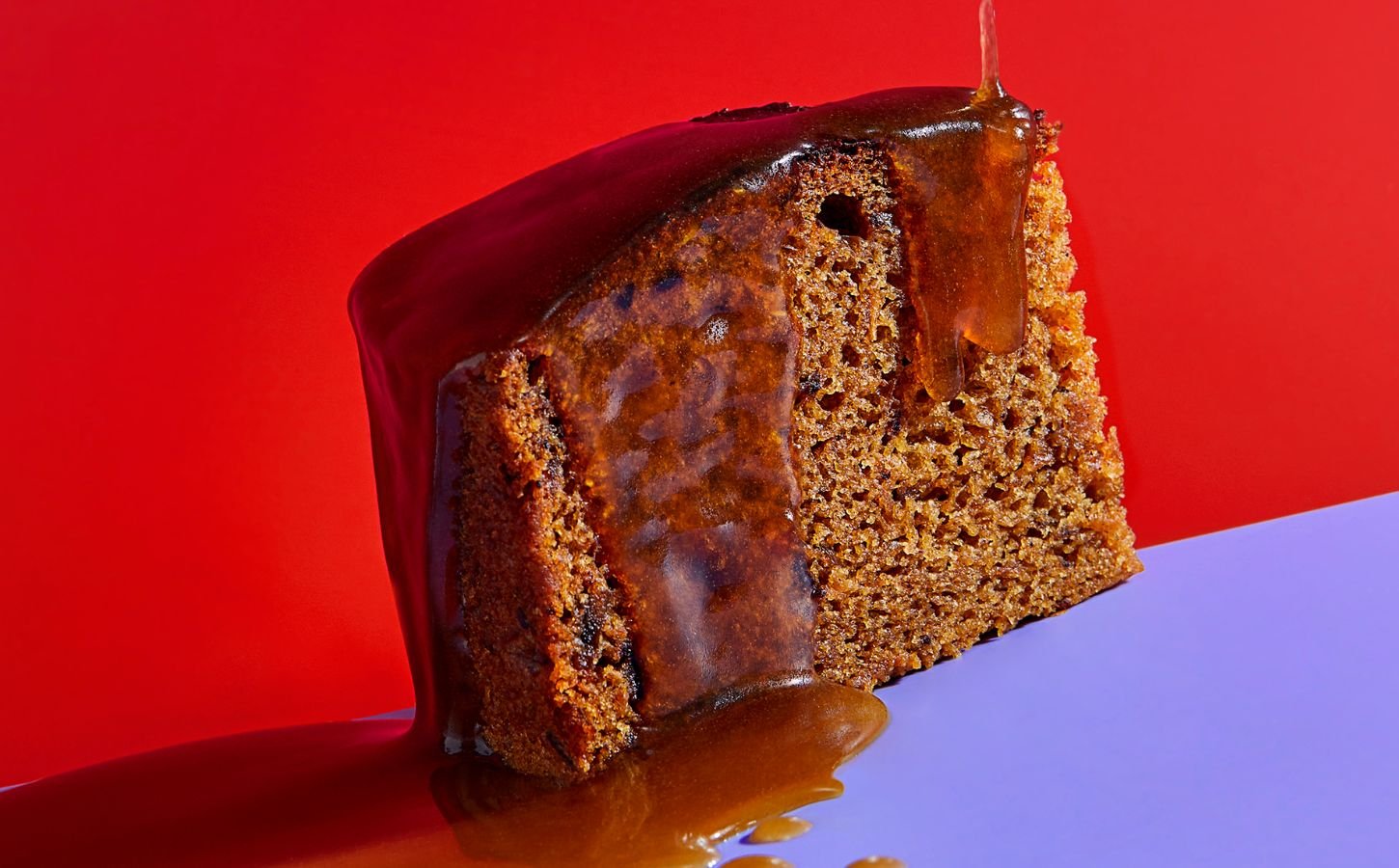 a slice of vegan sticky date pudding made with a plant-based butterscotch sauce