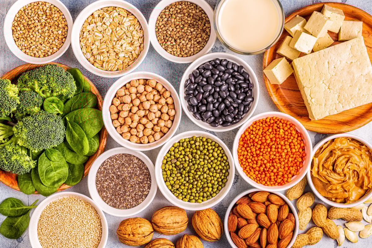 Photo shows bowls of ingredients known for their plant-based protein, from lentils and beans to broccoli and tofu