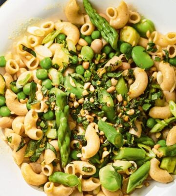 a summer veg and white bean pasta with edamame and asparagus
