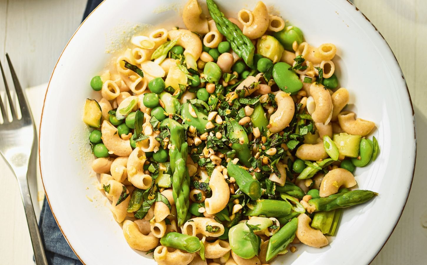 a summer veg and white bean pasta with edamame and asparagus