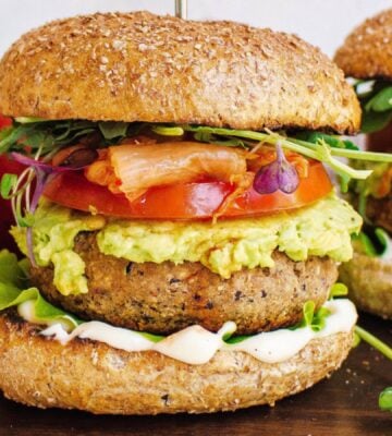 Two tempeh and apple burgers with tomato and avocado
