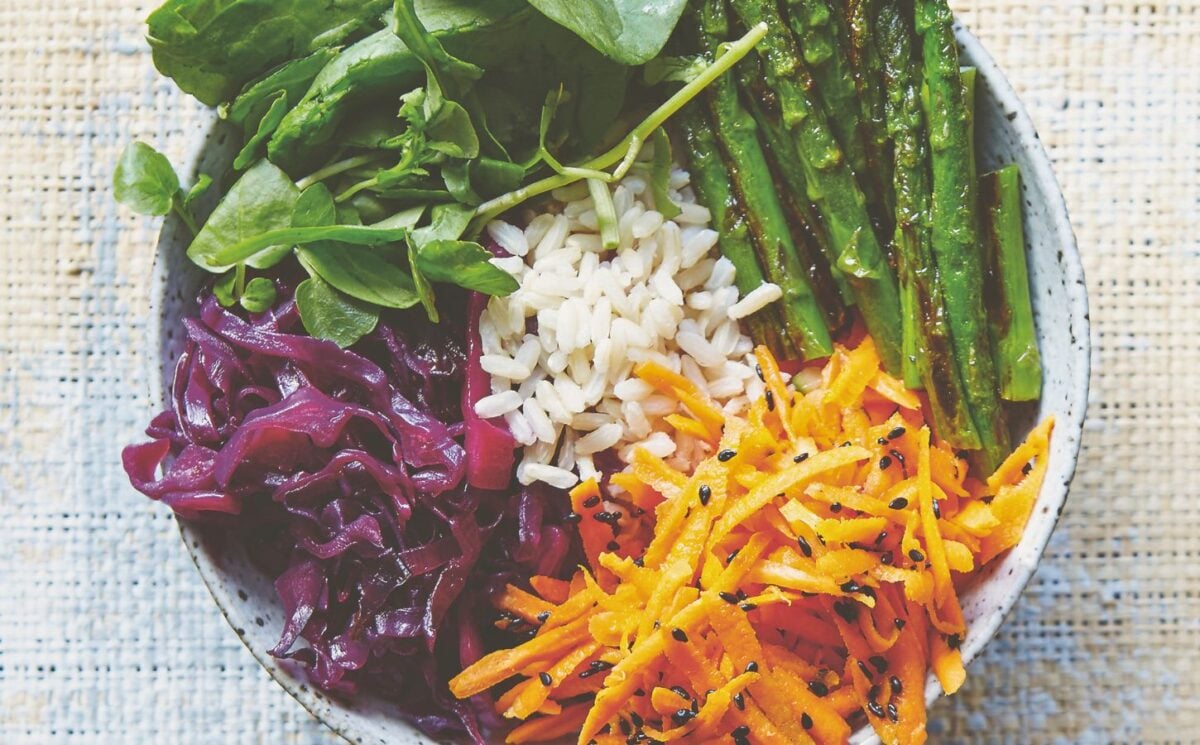 vegan bibimbap with cabbage, white rice, shallots, sweet and sour dressing, and asparagus