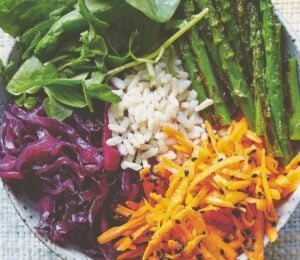 vegan bibimbap with cabbage, white rice, shallots, sweet and sour dressing, and asparagus