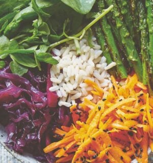 vegan bibimbap with cabbage, white rice, shallots, sweet and sour dressing, and asparagus