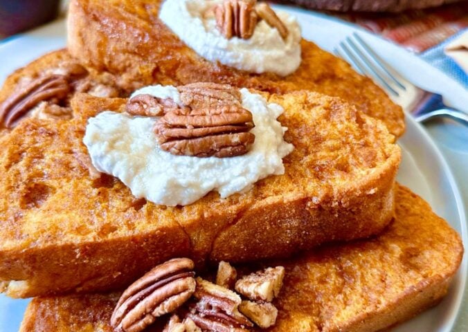 oven-baked French toast with pumpkin batter, coconut whipped cream, cinnamon and pecans for vegan brunch recipes