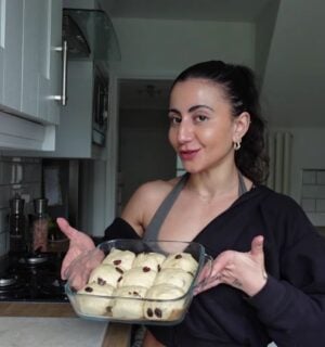 a picture of Leila Hannoun holding hot cross buns for her vegan café
