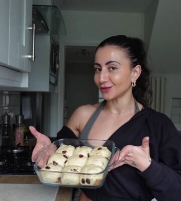 a picture of Leila Hannoun holding hot cross buns for her vegan café