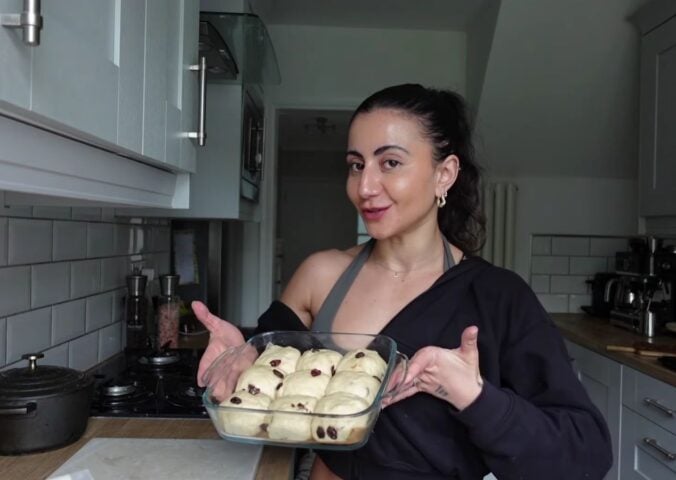 a picture of Leila Hannoun holding hot cross buns for her vegan café
