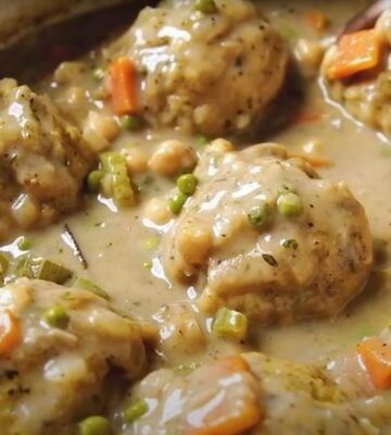 A saucepan containing a vegan chicken dumplings recipe, the ultimate plant-based comfort food