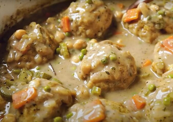 A saucepan containing a vegan chicken dumplings recipe, the ultimate plant-based comfort food