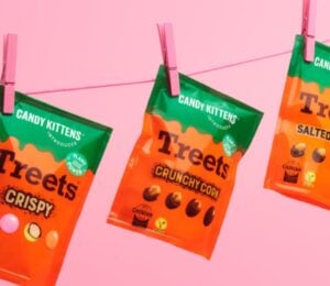 Photo shows all three varieties of the new Candy Kittens x Treets vegan chocolates pegged to a line against a pink background