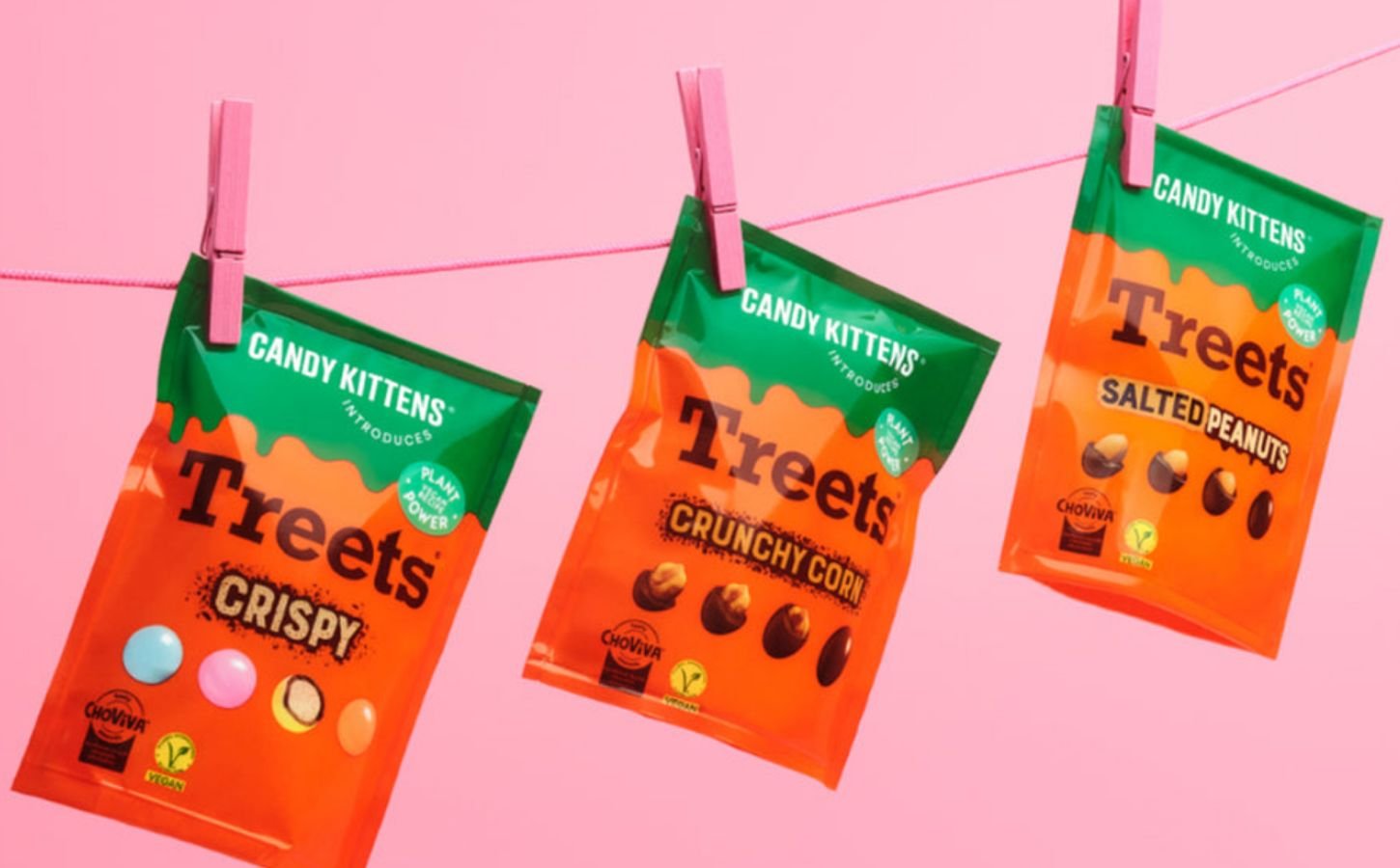 Photo shows all three varieties of the new Candy Kittens x Treets vegan chocolates pegged to a line against a pink background