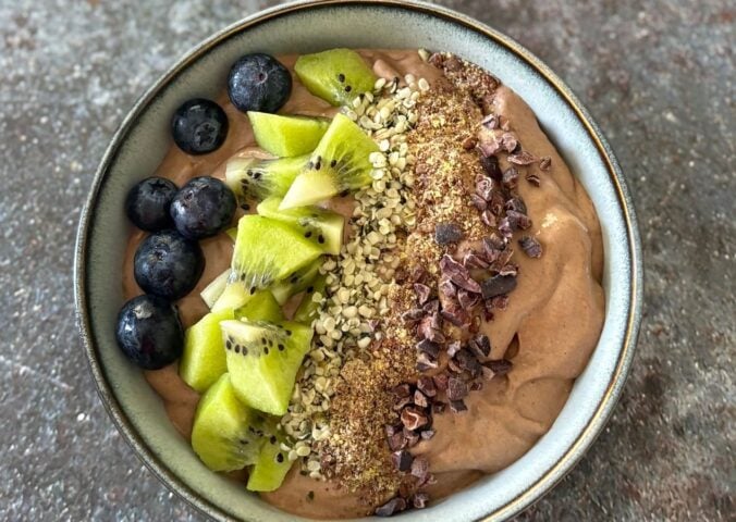 A vegan chocolate smoothie bowl featuring fresh fruit