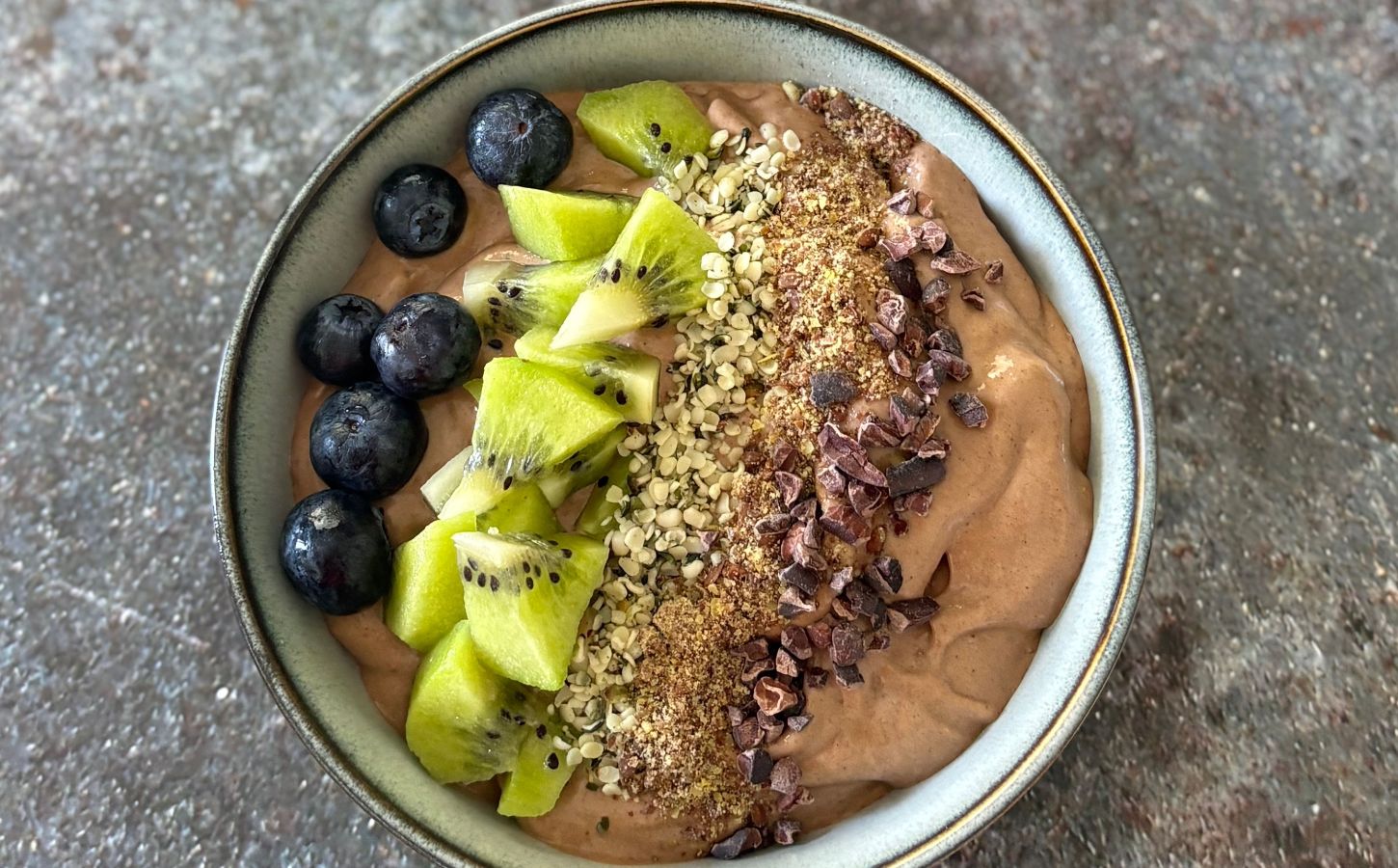 A vegan chocolate smoothie bowl featuring fresh fruit