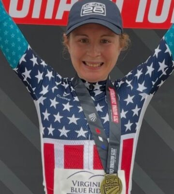 Photo shows vegan cyclist Emily Ehrlich celebrating her recent time trial win