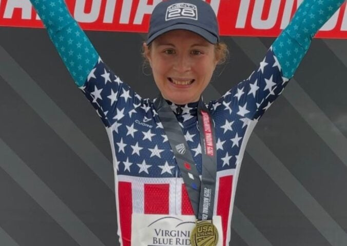 Photo shows vegan cyclist Emily Ehrlich celebrating her recent time trial win