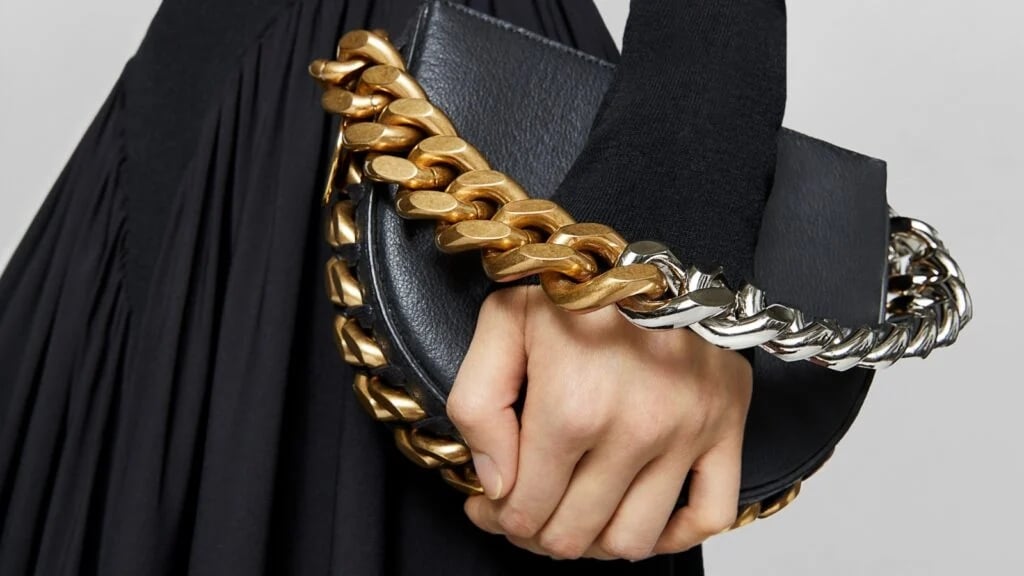 A woman holding a black Stella McCartney bag made with mycelium
