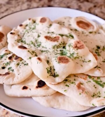 A plate full of homemade vegan naan recipe with dairy-free garlic butter