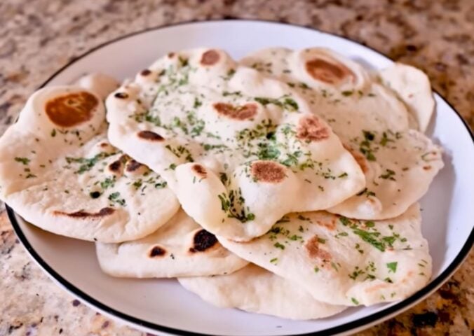 A plate full of homemade vegan naan recipe with dairy-free garlic butter
