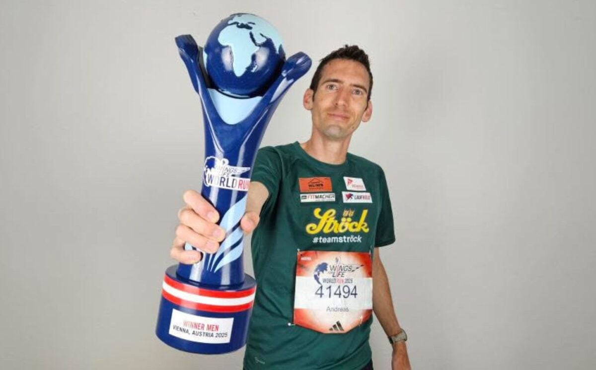 Vegan runner Andreas Vojta holding a trophy for Wings for Life World Run