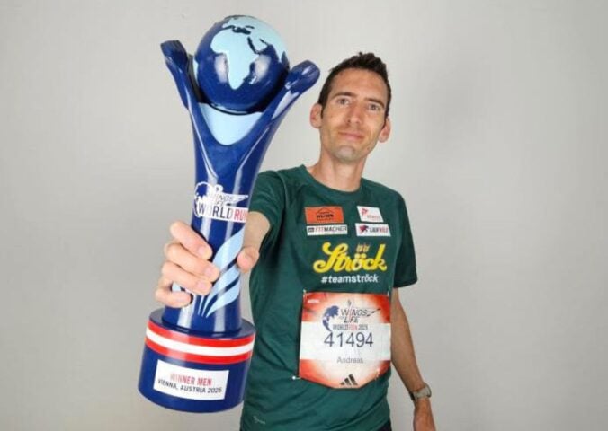 Vegan runner Andreas Vojta holding a trophy for Wings for Life World Run