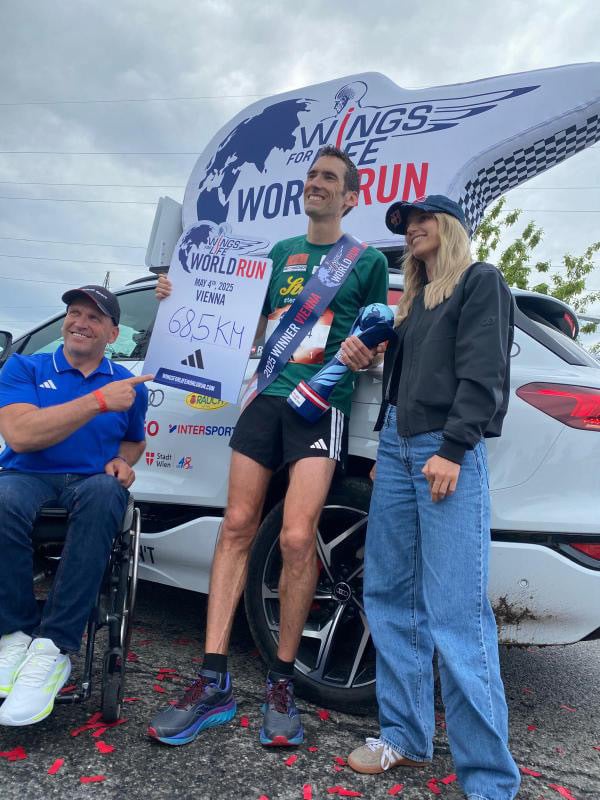 Vegan runner Andreas Vojta holding a trophy for Wings for Life World Run