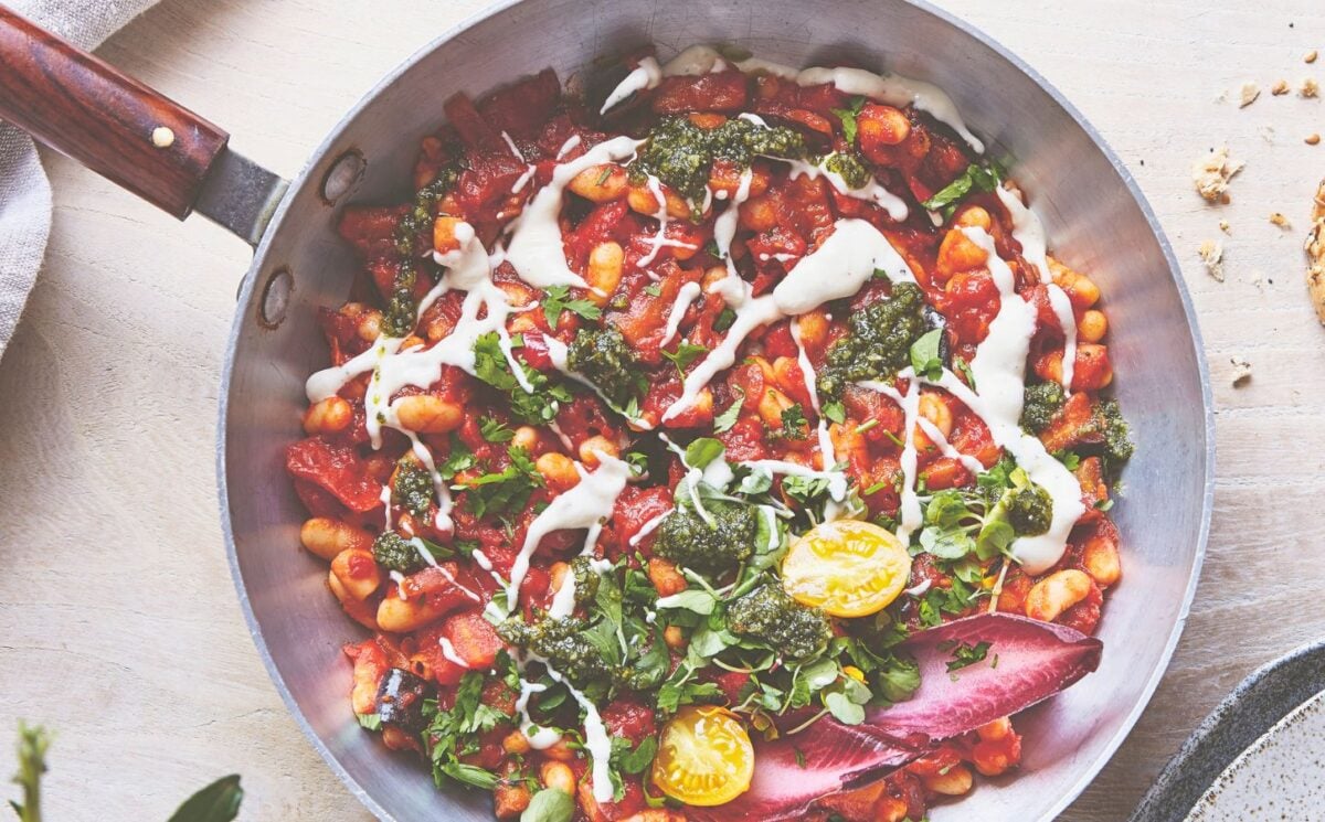 a pan of baked shakshuka with butter beans and aubergine