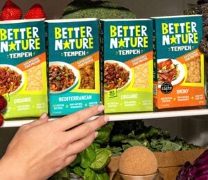Photo showss someone reaching for a pack of the new mediterranean tempeh from Better Nature