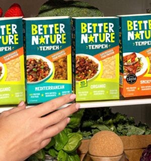 Photo showss someone reaching for a pack of the new mediterranean tempeh from Better Nature