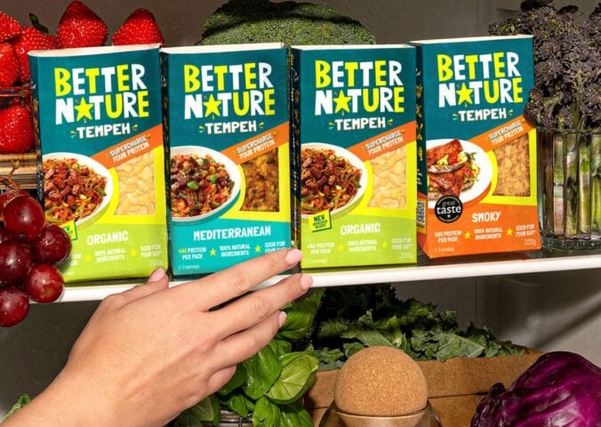 Photo showss someone reaching for a pack of the new mediterranean tempeh from Better Nature