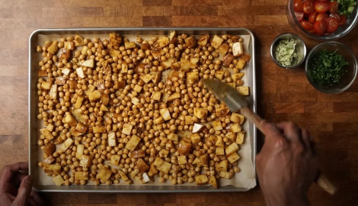 Chickpeas and potatoes in a roasting tin for a chickpea and potato bowl recipe