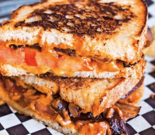 a vegan chipotle grilled cheese with caramelized onions made with cashew cheese