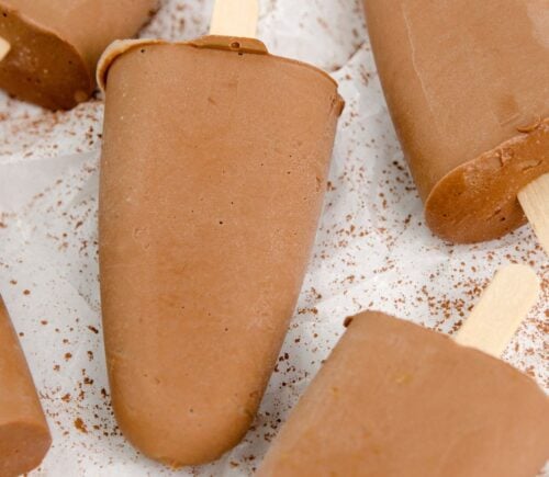 homemade vegan fudgesicles made with cocoa powder, nut butter, plant-based milk, and coconut sugar