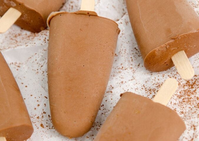 homemade vegan fudgesicles made with cocoa powder, nut butter, plant-based milk, and coconut sugar