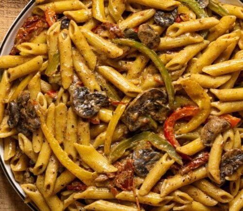 vegan grand rasta pasta with three colors of bell pepper