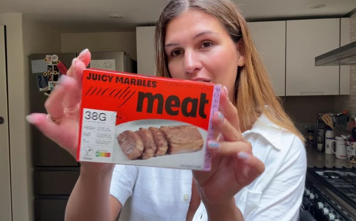 Vegan content creator Nicole Whittle holding up a pack of Juicy Marbles pork