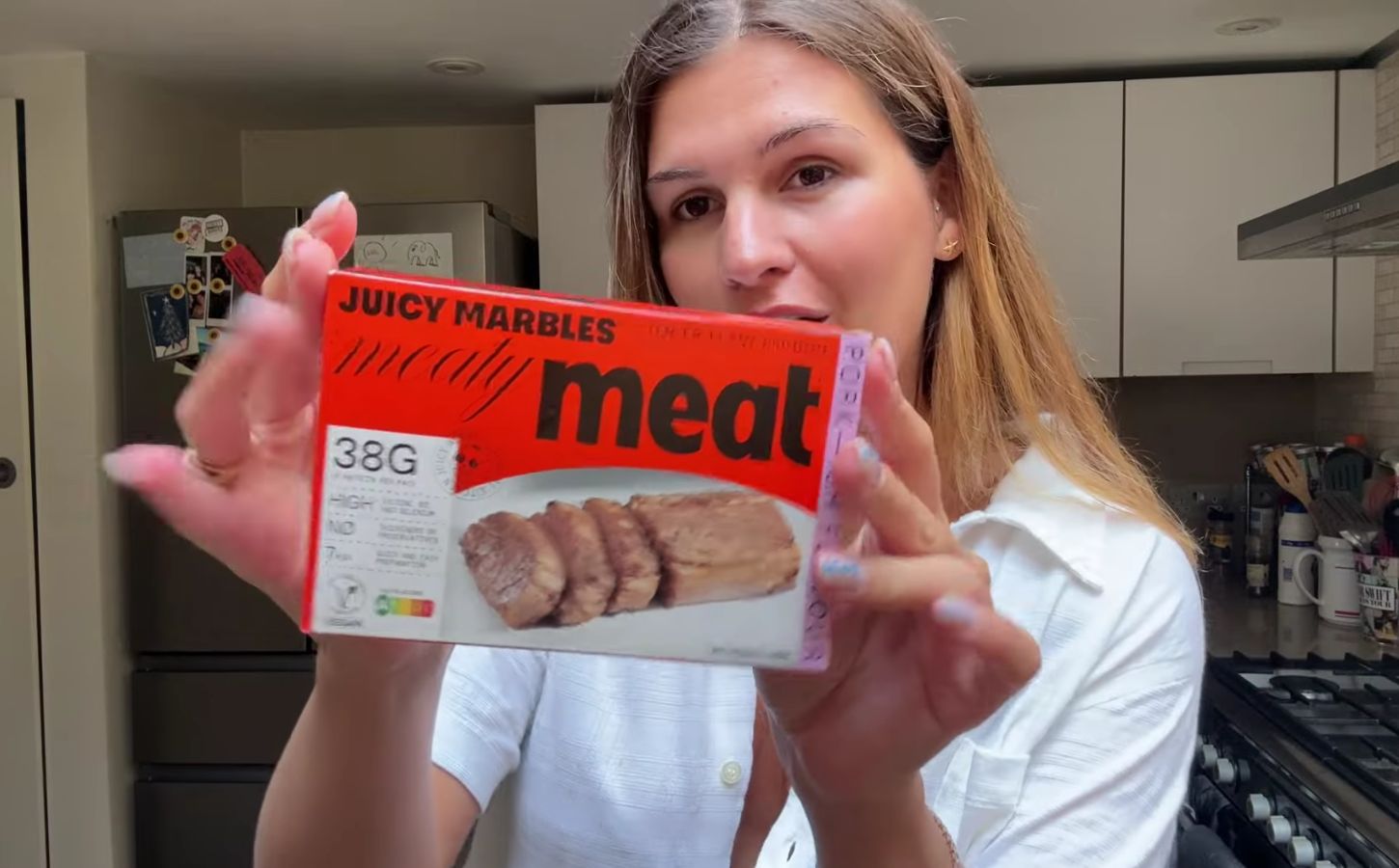 Vegan content creator Nicole Whittle holding up a pack of Juicy Marbles pork