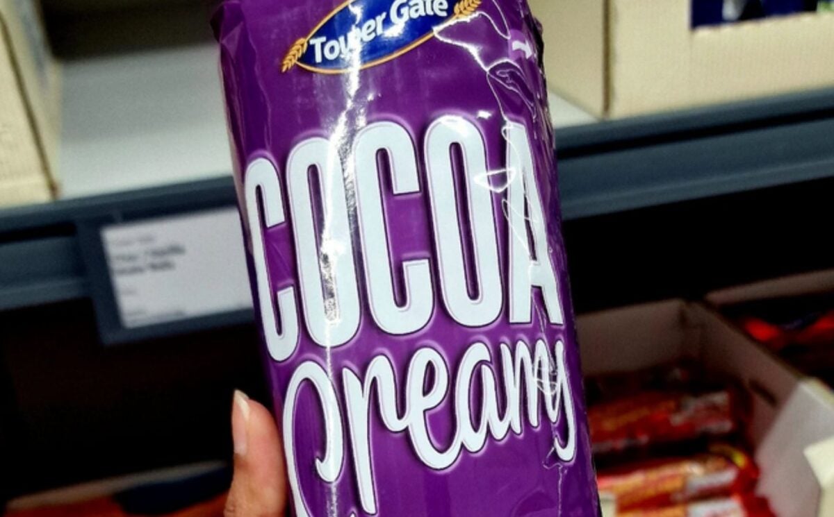 Photo shows someone holding up a pack of Lidl's new "Cocoa Creamy" vegan biscuits