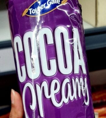 Photo shows someone holding up a pack of Lidl's new "Cocoa Creamy" vegan biscuits