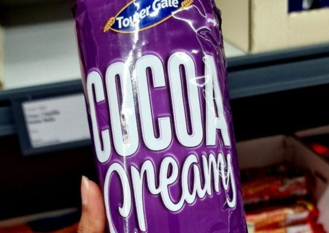 Photo shows someone holding up a pack of Lidl's new "Cocoa Creamy" vegan biscuits