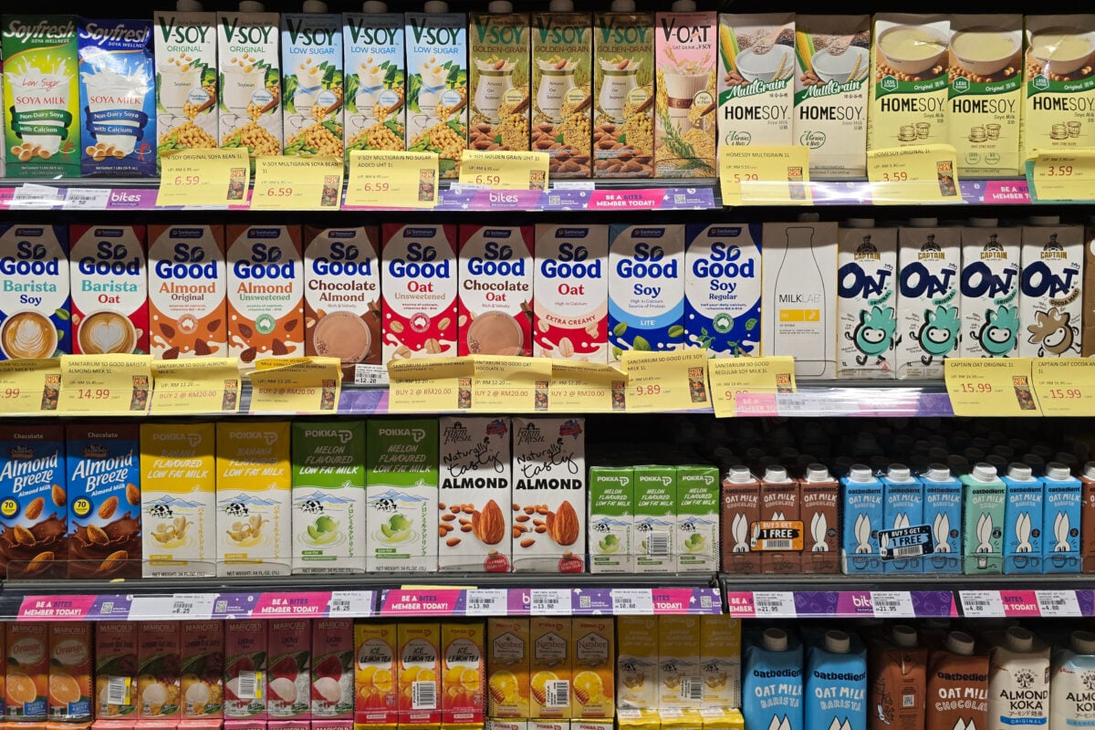 Photo shows a selection of nondairy milk cartons in a supermarket