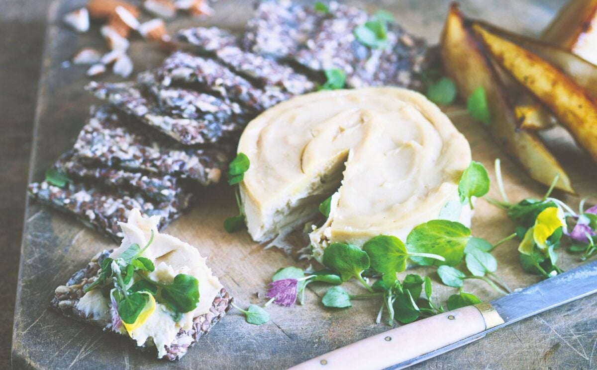 a board of truffled cashew cheese and caramelized pears with seed crackers