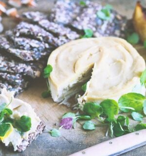 a board of truffled cashew cheese and caramelized pears with seed crackers