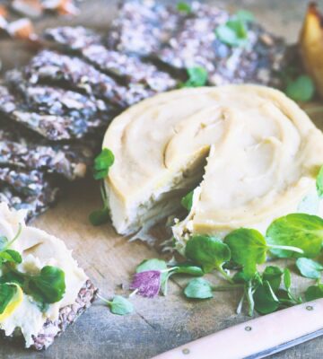 a board of truffled cashew cheese and caramelized pears with seed crackers