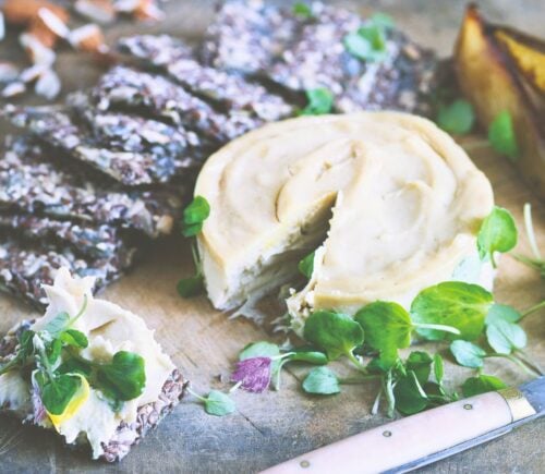a board of truffled cashew cheese and caramelized pears with seed crackers