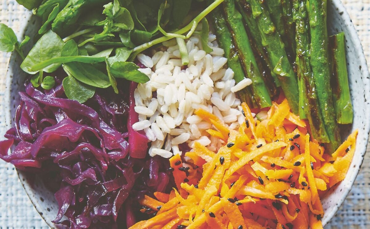 vegan bibimbap with cabbage, white rice, shallots, sweet and sour dressing, and asparagus for Korean-inspired vegan recipes